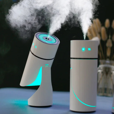 Two white humidifiers with blue lights emitting steam on a dark background