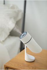 White desk lamp with blue light on a wooden surface