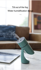 Green humidifier on a table with a blurred background