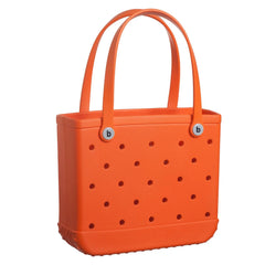 Orange tote bag with polka dot pattern and visible brand logo on a white background