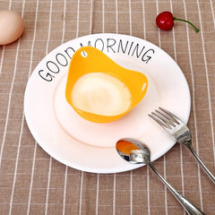 Egg-shaped yellow object on a plate with 'Good Morning' text, surrounded by a fork and spoon on a checkered tablecloth.
