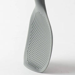 Gray kitchen spatula with textured surface on a white background