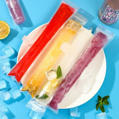 Five colorful popsicles on a white plate with ice cubes on a blue background