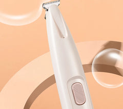 White electric razor on a peach background