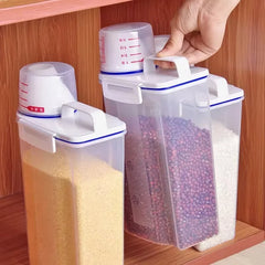 Clear plastic storage containers with measurement markings on a wooden shelf.