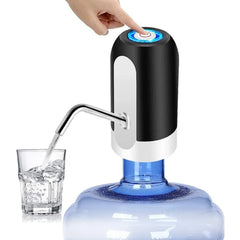 Hand pressing a button on a water dispenser with a glass of water below.
