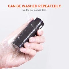 Hand holding a black bar of soap with text about its durability and benefits.