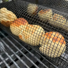 Corn on the cob in a mesh grill basket over a grill