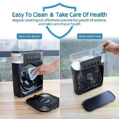 Portable fan with cleaning instructions on a wooden surface