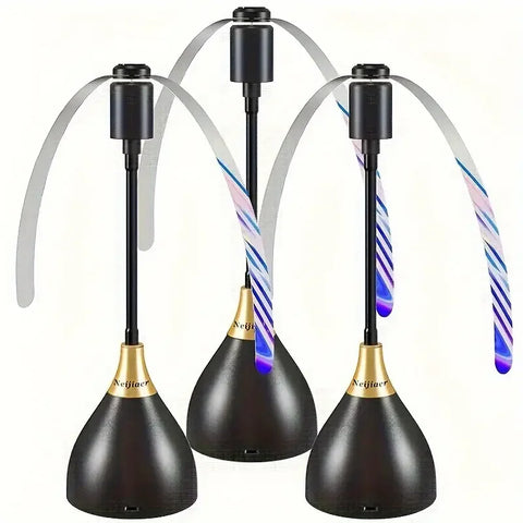 Three black and gold lamps with colorful ribbons on a white background