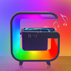 Black portable speaker with rainbow light effects on a colorful gradient background