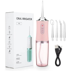 Pink oral irrigator with packaging, attachments, and USB cable on a white background