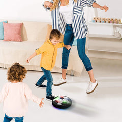 Children playing with a hover ball in a living room