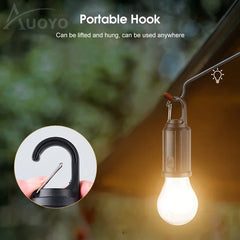 Portable hook with light bulb attachment on a blurred natural background