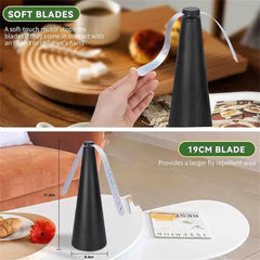 Black fly repellent device with a measuring tape for scale, used on a table.