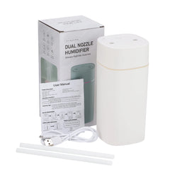 White dual nozzle humidifier with packaging, user manual, and USB cable on a white background