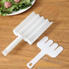 White plastic tool on a wooden surface with a plate of food in the background