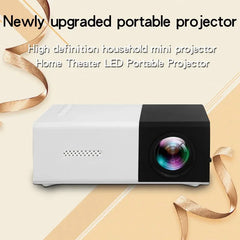 Portable projector with decorative ribbons on a beige background
