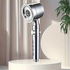 Chrome handheld shower head on a white stand with a neutral background