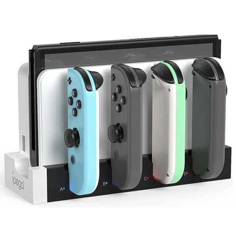 Four Nintendo Switch Joy-Con controllers in different colors on a charging stand.