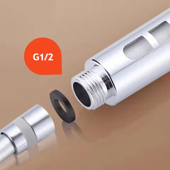 Chrome plumbing fitting with G1/2 marking on a brown background