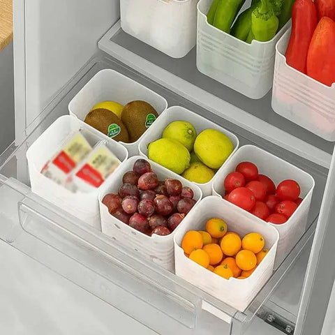 Fruit and vegetable compartments in a refrigerator with neatly arranged items.