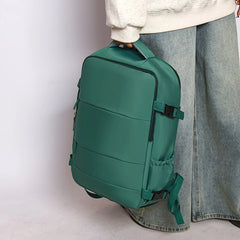 Green backpack held by a person against a plain background