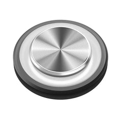 Metallic circular object with concentric circles on a white background