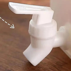 White plastic valve on a wooden surface with an arrow pointing to it.