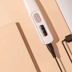 White electronic device with control panel on a beige surface