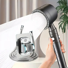 Handheld shower head with flexible hose held by a hand, with a neutral background