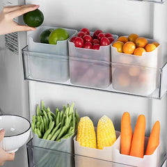 Fruit and vegetable storage bins inside a refrigerator with fresh produce.