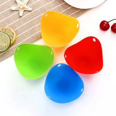Four colorful silicone ice cube trays on a white surface with a starfish and fruit in the background.