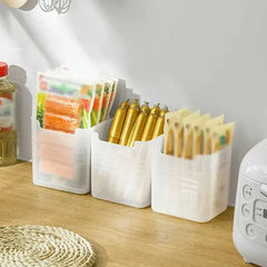 Three white containers holding various food items on a wooden surface.