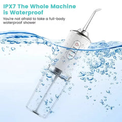 Waterproof dental cleaning device with water splashes on a white background