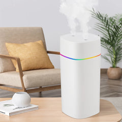White humidifier with rainbow light on a wooden table in a living room setting.