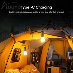 Camping tent with lights inside, featuring Auoyo branding and Type-C charging text.