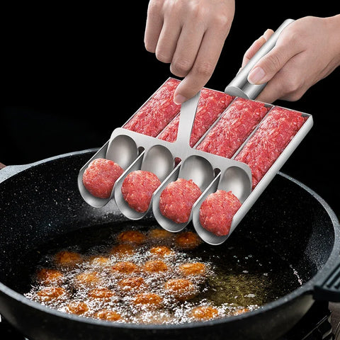 Person using a meatball maker to cook meatballs in a frying pan.