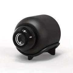 Black cylindrical device with a reflective surface on a white background