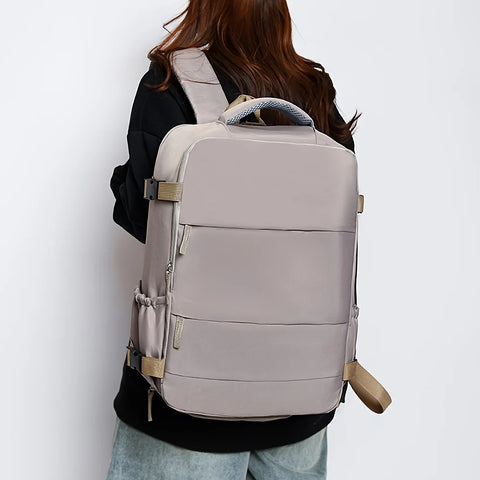 Person wearing a beige backpack on a plain background