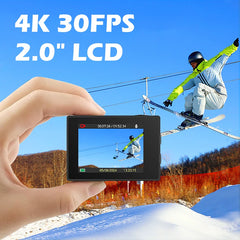 Person holding a small camera with a snowy landscape and skier in the background
