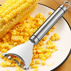 Corn shaver with corn kernels on a plate