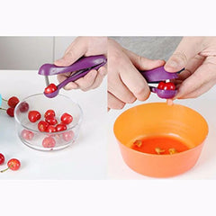 Purple cherry pitter being used to remove cherry pits from a bowl.
