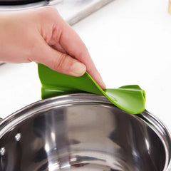 Green silicone lid lock being used on a metal pot