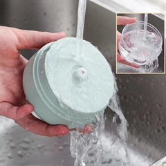 Person holding a light blue silicone cup under running water 