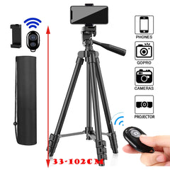 A black 100cm phone tripod with Bluetooth remote, shown with a smartphone attached and in its carrying case.