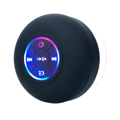 A waterproof mini stereo with LED light attached to a shower wall, next to a woman enjoying the shower.