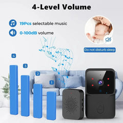 Baby monitor with volume control features and a baby sleeping in a crib.